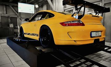 Gelber Porsche GT3 Cup auf dem Allrad-Prüfstand in der Messhalle